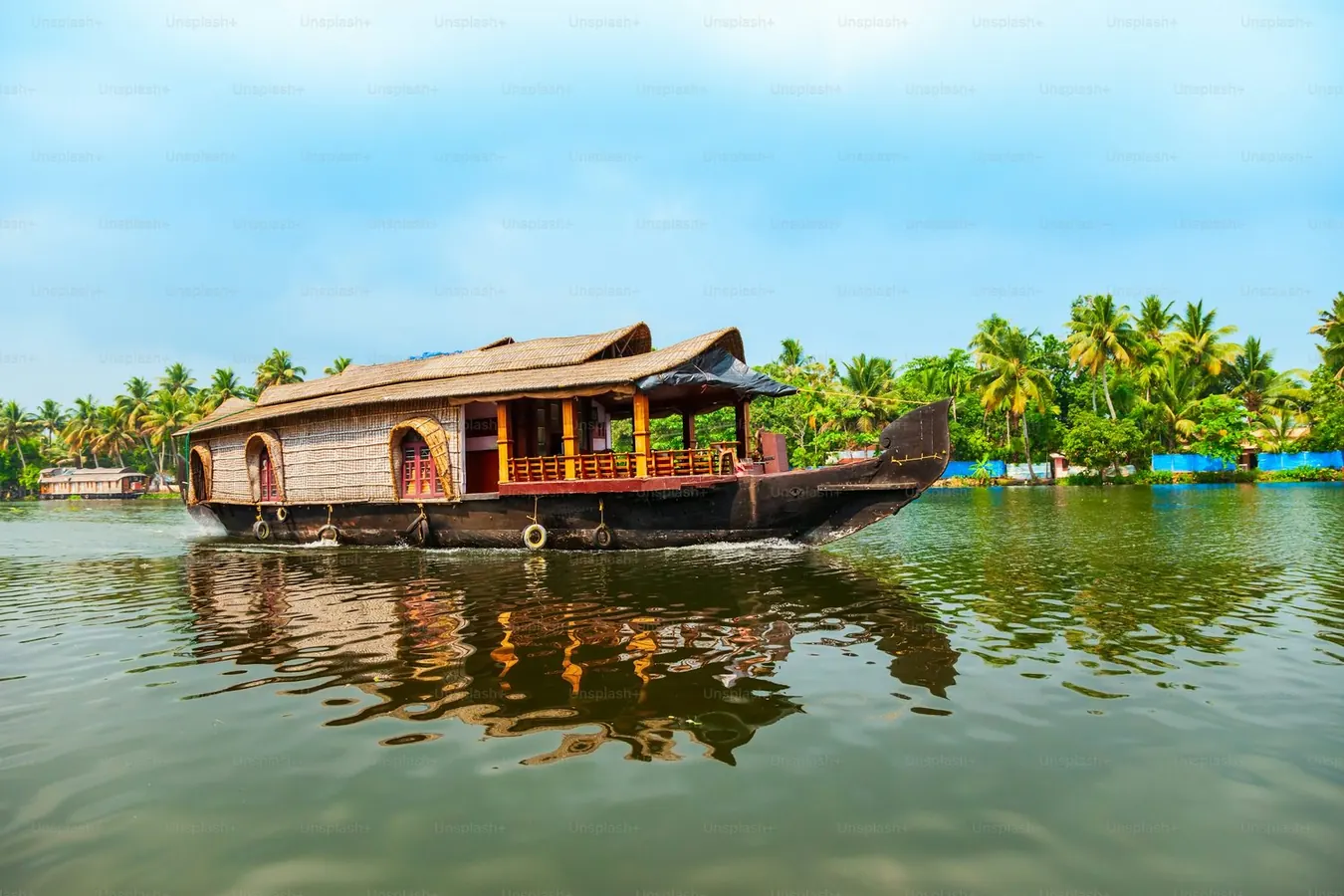 A traditional houseboat travelling through Kerala backwaters